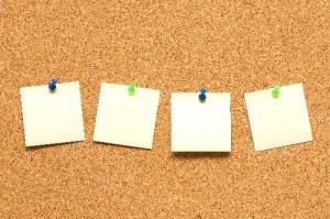 Yellow post it notes on the corkboard